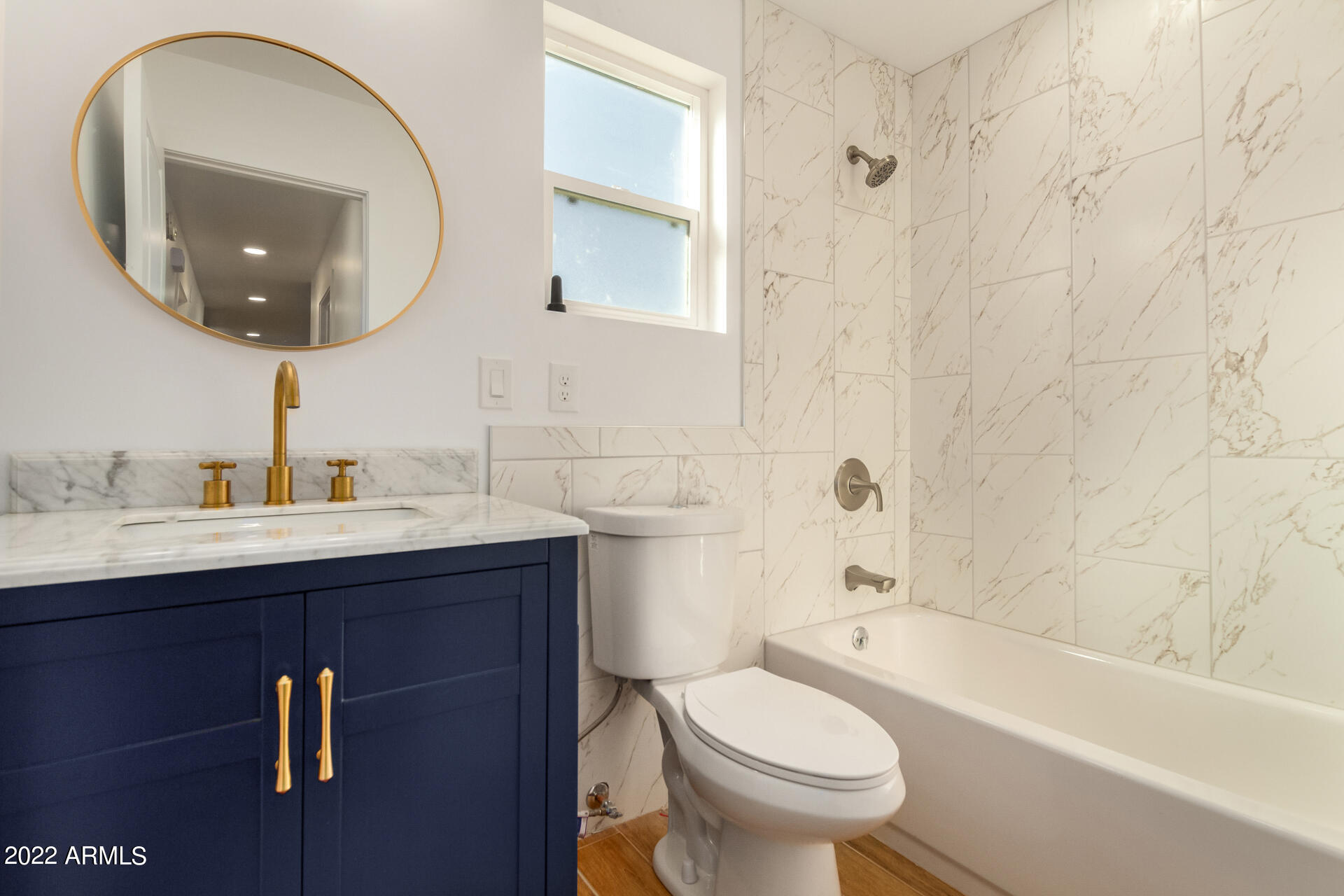 4110 East Vineyard Road Phoenix, AZ 85042 - Photo 20 of 31 a bathroom with a sink a toilet and a mirror