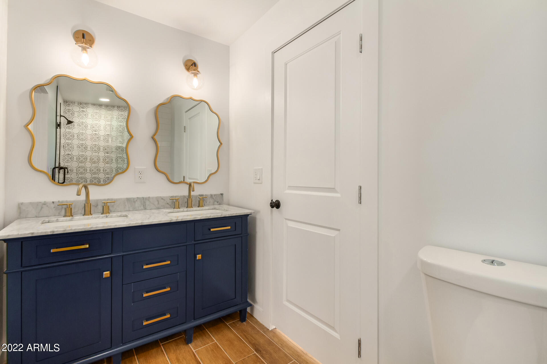 4110 East Vineyard Road Phoenix, AZ 85042 - Photo 22 of 31 a bathroom with a double vanity sink and a mirror
