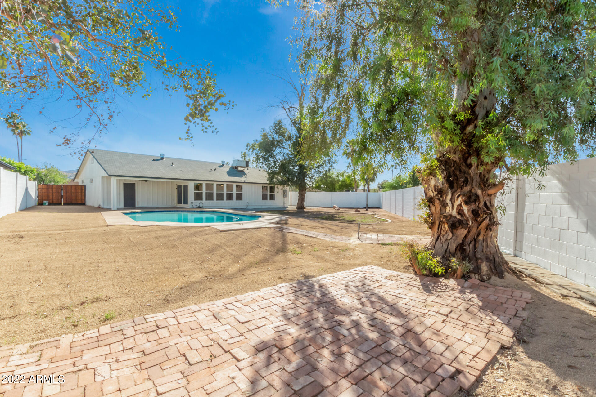 4110 East Vineyard Road Phoenix, AZ 85042 - Photo 29 of 31 a view of house with backyard and tree