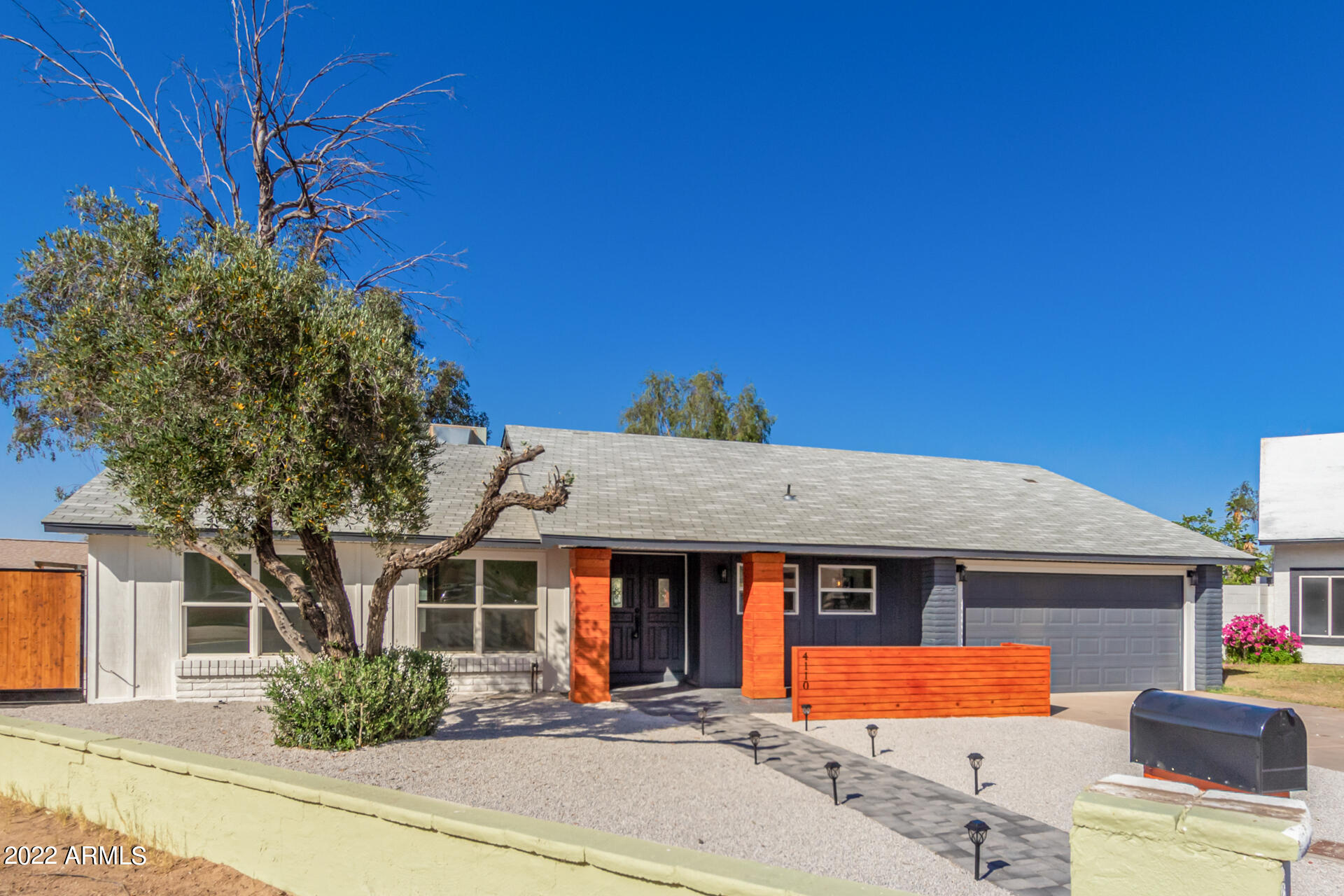 4110 East Vineyard Road Phoenix, AZ 85042 - Photo 4 of 31 a front view of a house with yard