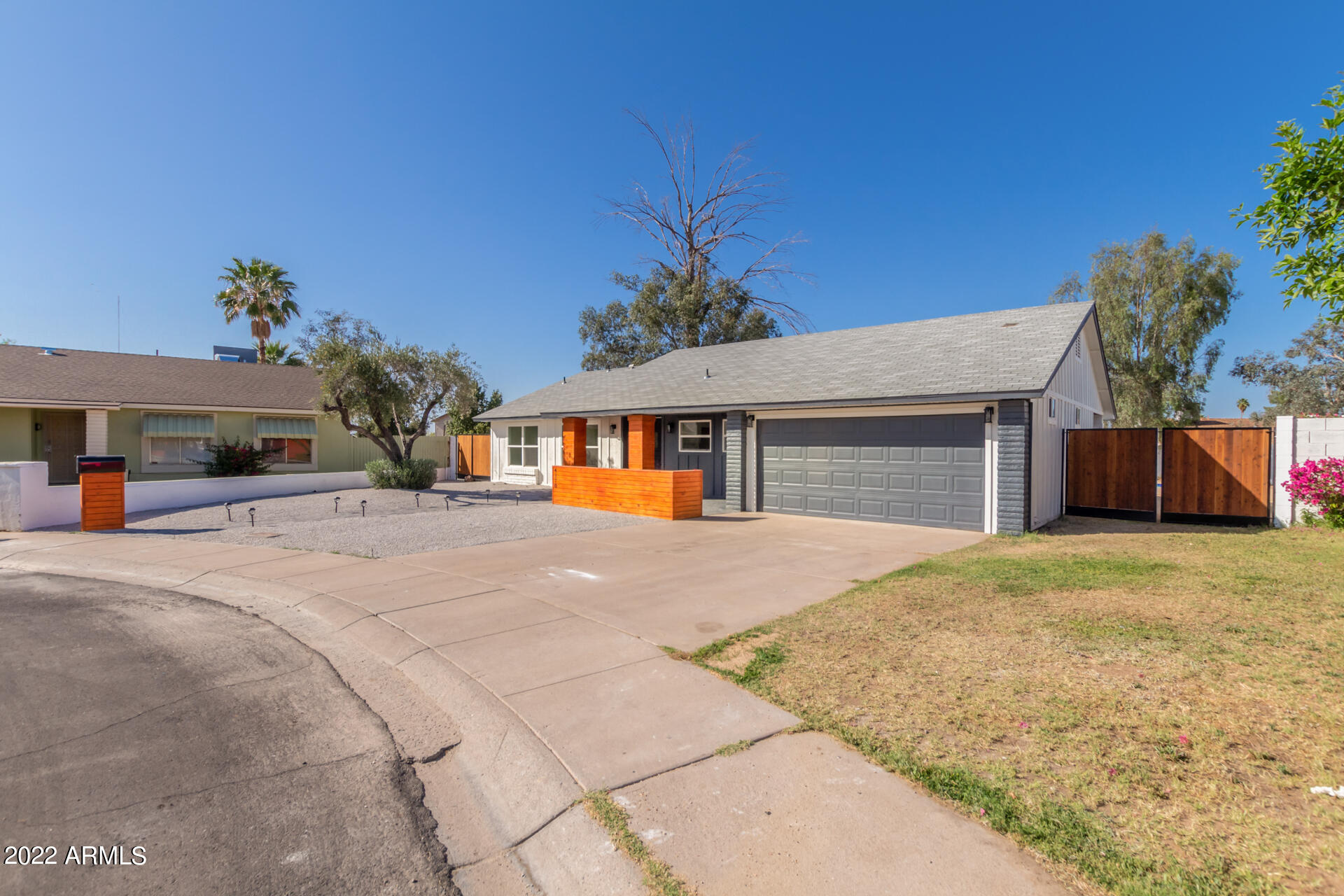 4110 East Vineyard Road Phoenix, AZ 85042 - Photo 5 of 31 a front view of a house with a yard and garage