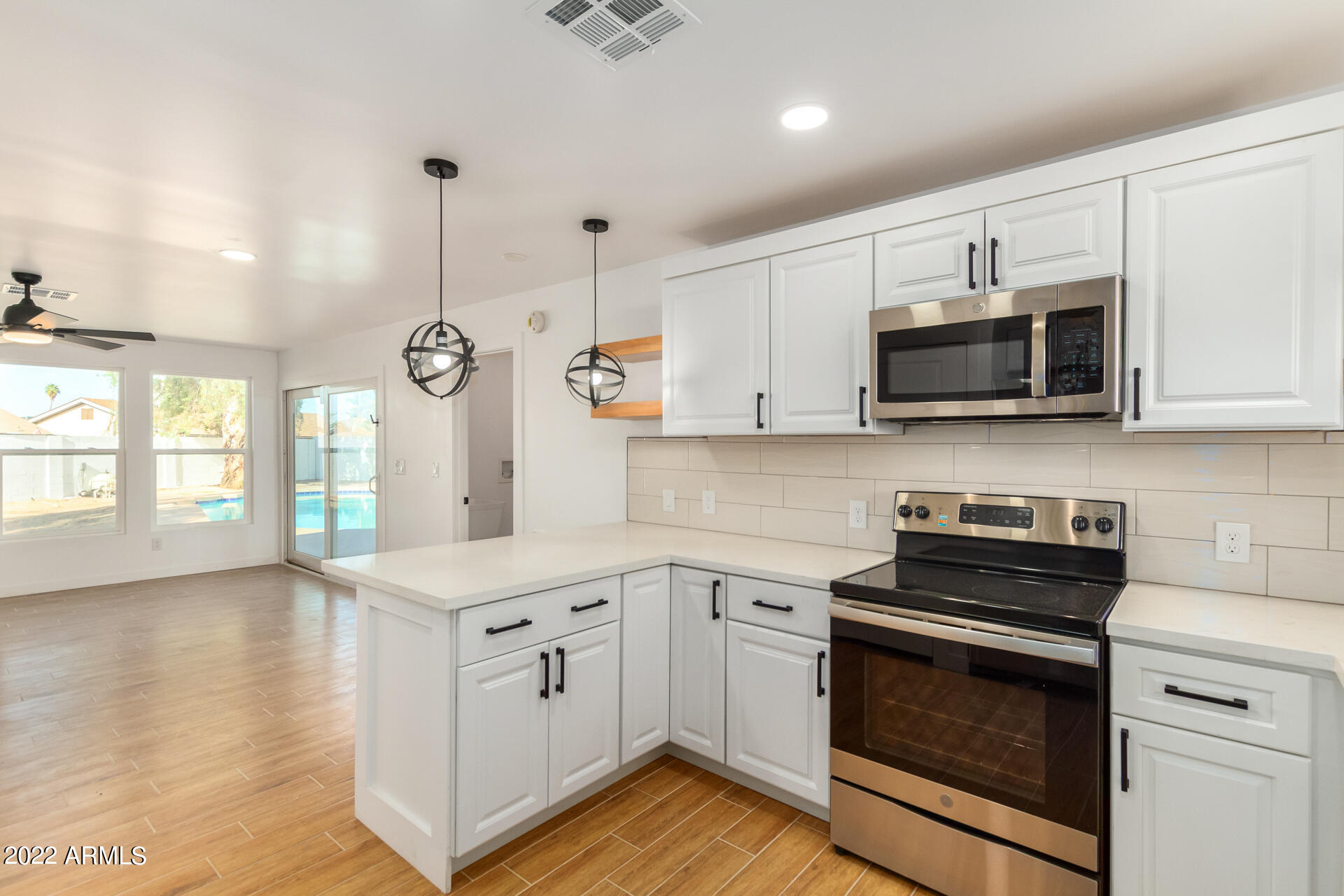 4110 East Vineyard Road Phoenix, AZ 85042 - Photo 10 of 31 a kitchen with a sink stove and microwave