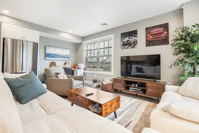 a living room with furniture flat screen tv and a fireplace