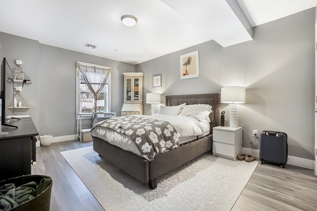 245 Bussey Street, Unit 205 Dedham, MA 02026 - Photo 12 of 17 a bedroom with a bed and a tv