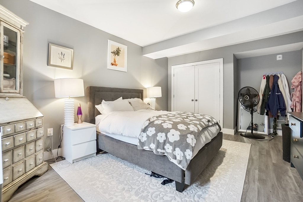 245 Bussey Street, Unit 205 Dedham, MA 02026 - Photo 13 of 17 a bed room with a bed and a night stand