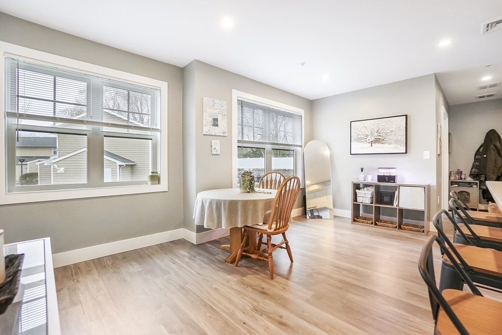 245 Bussey Street, Unit 205 Dedham, MA 02026 - Photo 8 of 17 a living room with furniture and a wooden floor