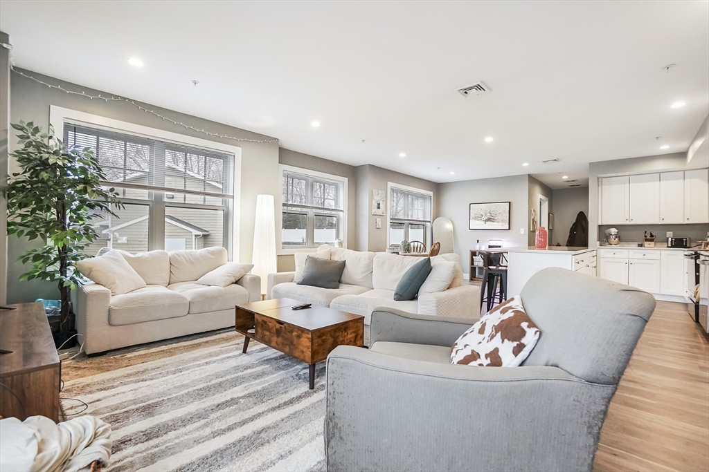 245 Bussey Street, Unit 205 Dedham, MA 02026 - Photo 9 of 17 a living room with furniture and a large window