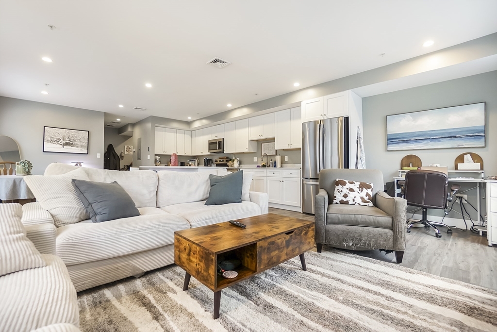 245 Bussey Street, Unit 205 Dedham, MA 02026 - Photo 10 of 17 a living room with furniture and a table