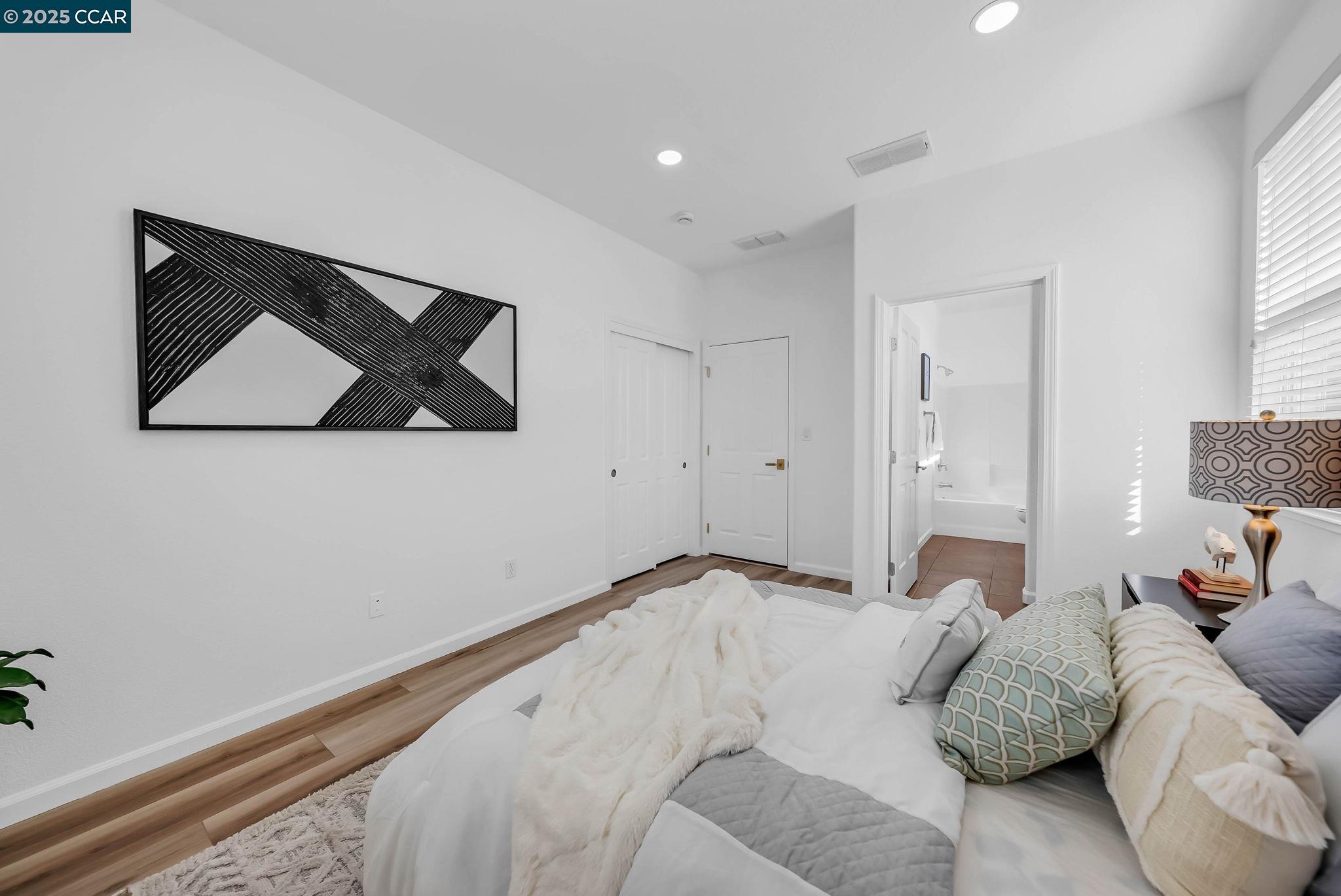 900 Brookside Lane Rio Vista, CA 94571 - Photo 11 of 60 a bedroom with a bed and wall painting