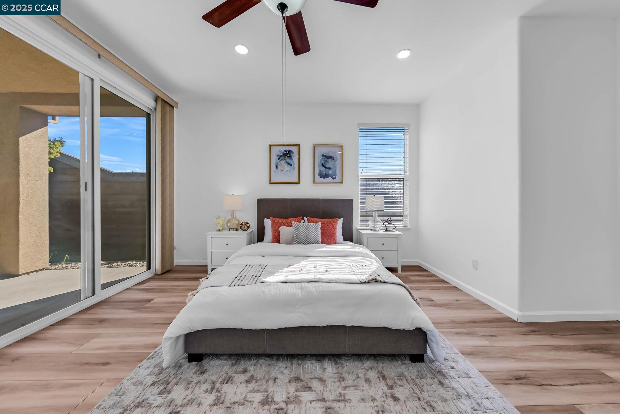 900 Brookside Lane Rio Vista, CA 94571 - Photo 36 of 60 a bedroom with a large bed and a wooden floor