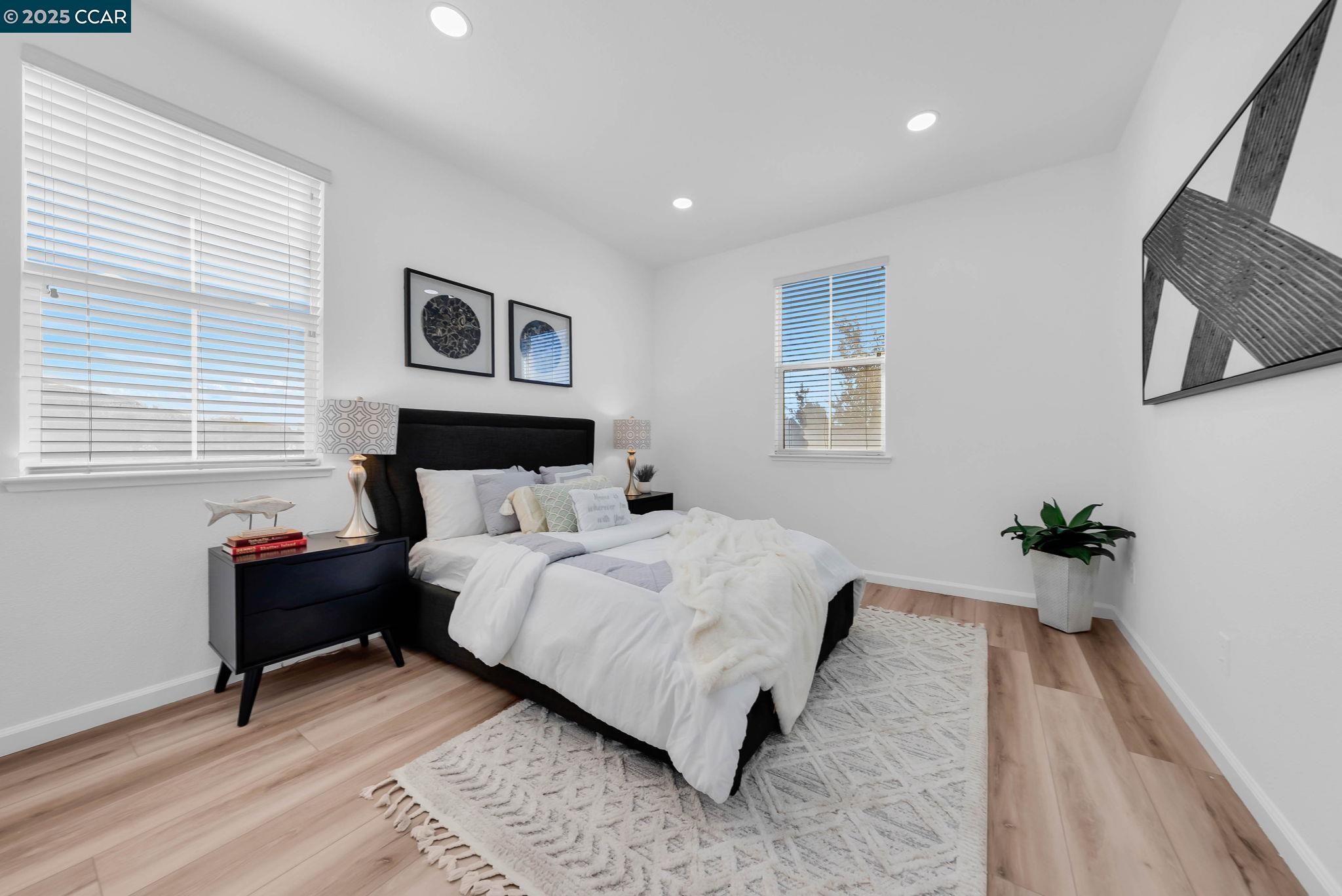 900 Brookside Lane Rio Vista, CA 94571 - Photo 8 of 60 a bed room with a bed and a potted plant