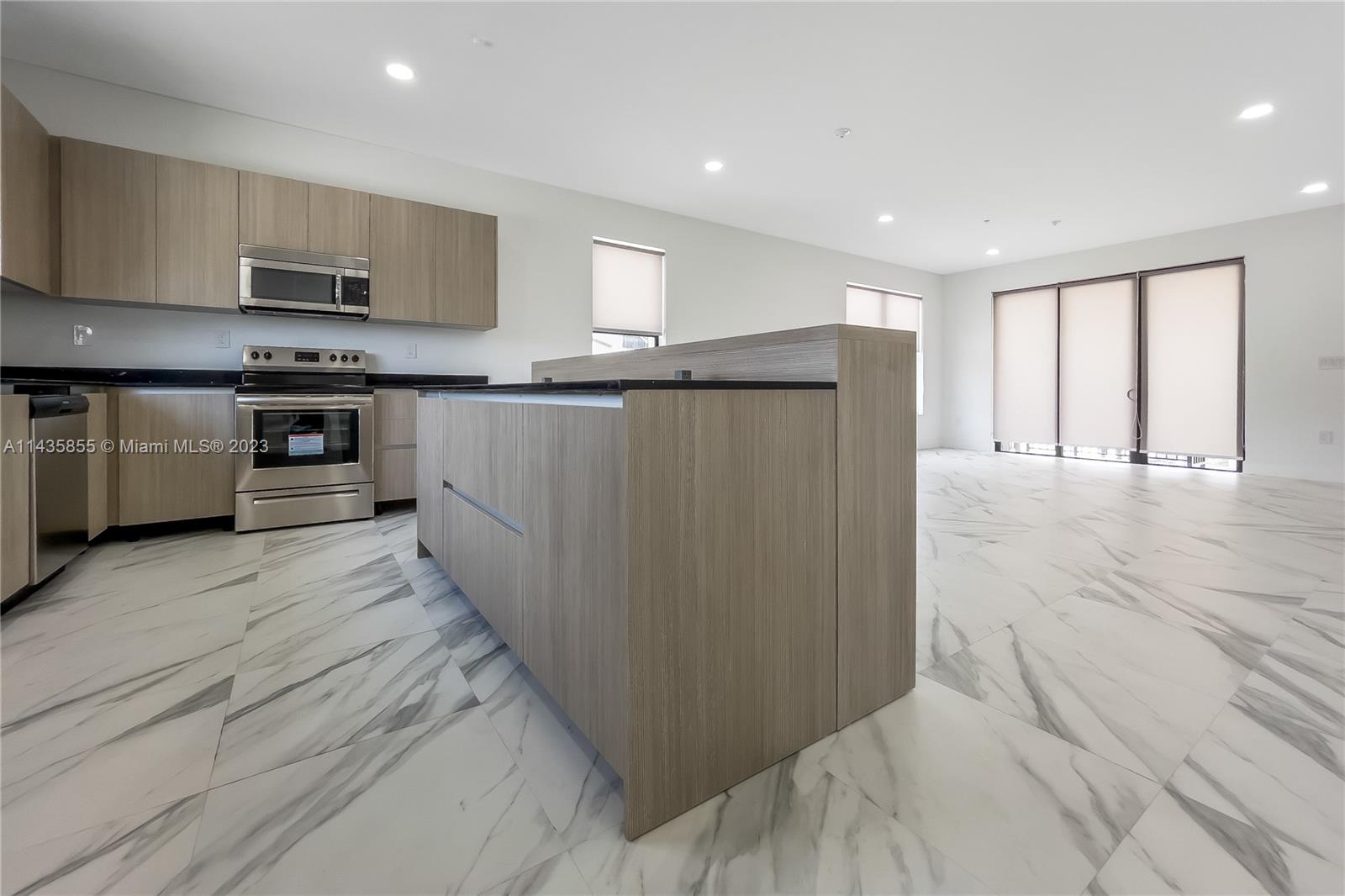 6151 Southwest 36th Court, Unit 25 Miramar, FL 33023 - Photo 1 of 1 a kitchen with stainless steel appliances granite countertop a refrigerator and a stove