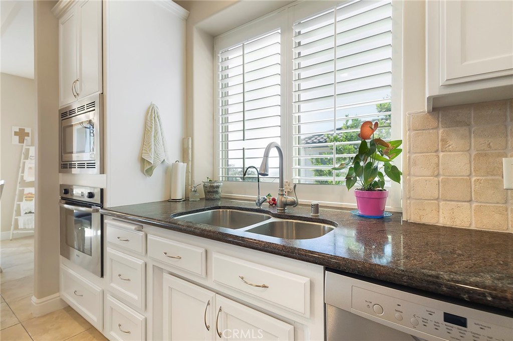 3294 Summit Ridge Terrace Chico, CA 95928 - Photo 19 of 68 a kitchen with stainless steel appliances granite countertop a sink a counter space and a window