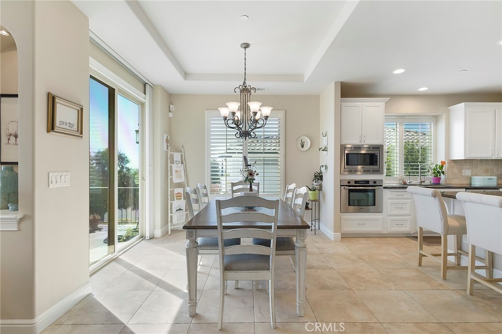 3294 Summit Ridge Terrace Chico, CA 95928 - Photo 23 of 68 a kitchen with stainless steel appliances kitchen island granite top table and chairs