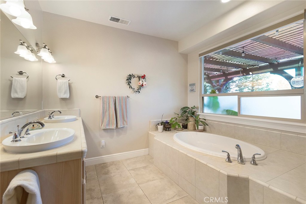 3294 Summit Ridge Terrace Chico, CA 95928 - Photo 29 of 68 a bathroom with a tub sink and mirror