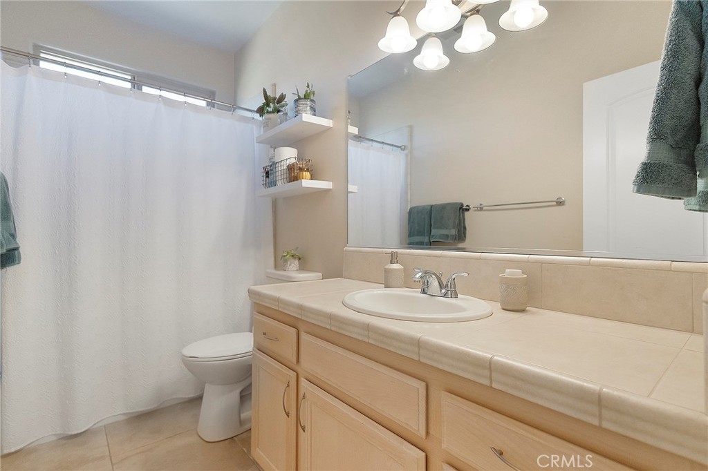 3294 Summit Ridge Terrace Chico, CA 95928 - Photo 34 of 68 a bathroom with a sink a toilet and a mirror