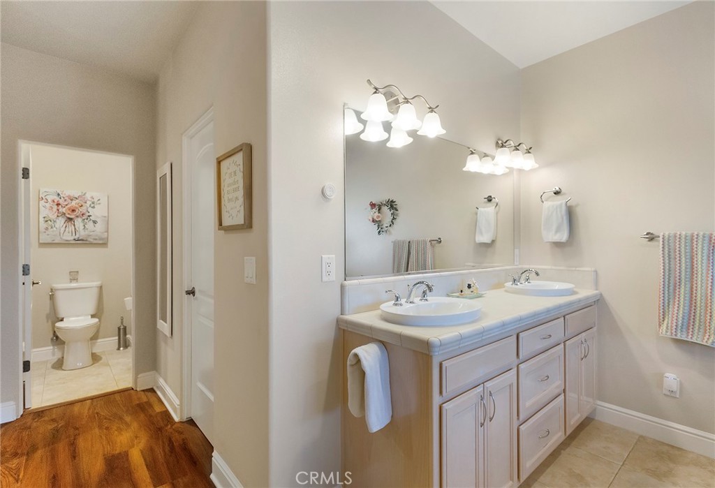 3294 Summit Ridge Terrace Chico, CA 95928 - Photo 38 of 68 a en suite bathroom with a double vanity sink and a mirror