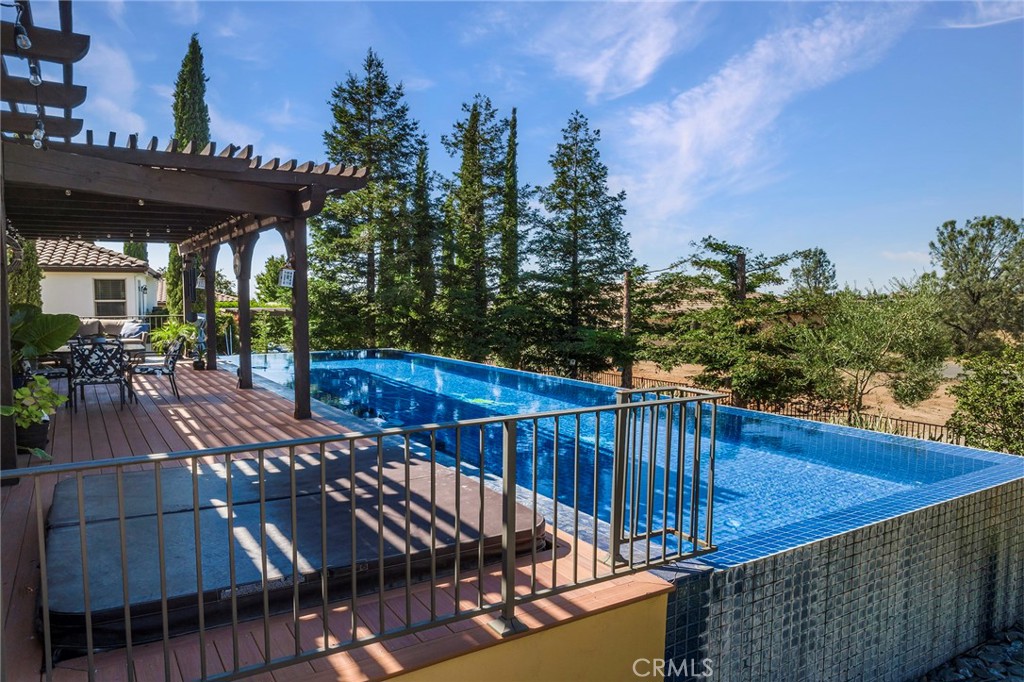 3294 Summit Ridge Terrace Chico, CA 95928 - Photo 62 of 68 a view of a roof deck with table and chairs with wooden floor and fence