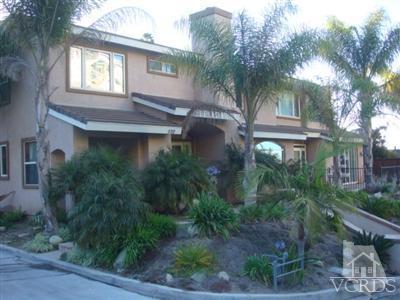 a view of a house with a yard and plants