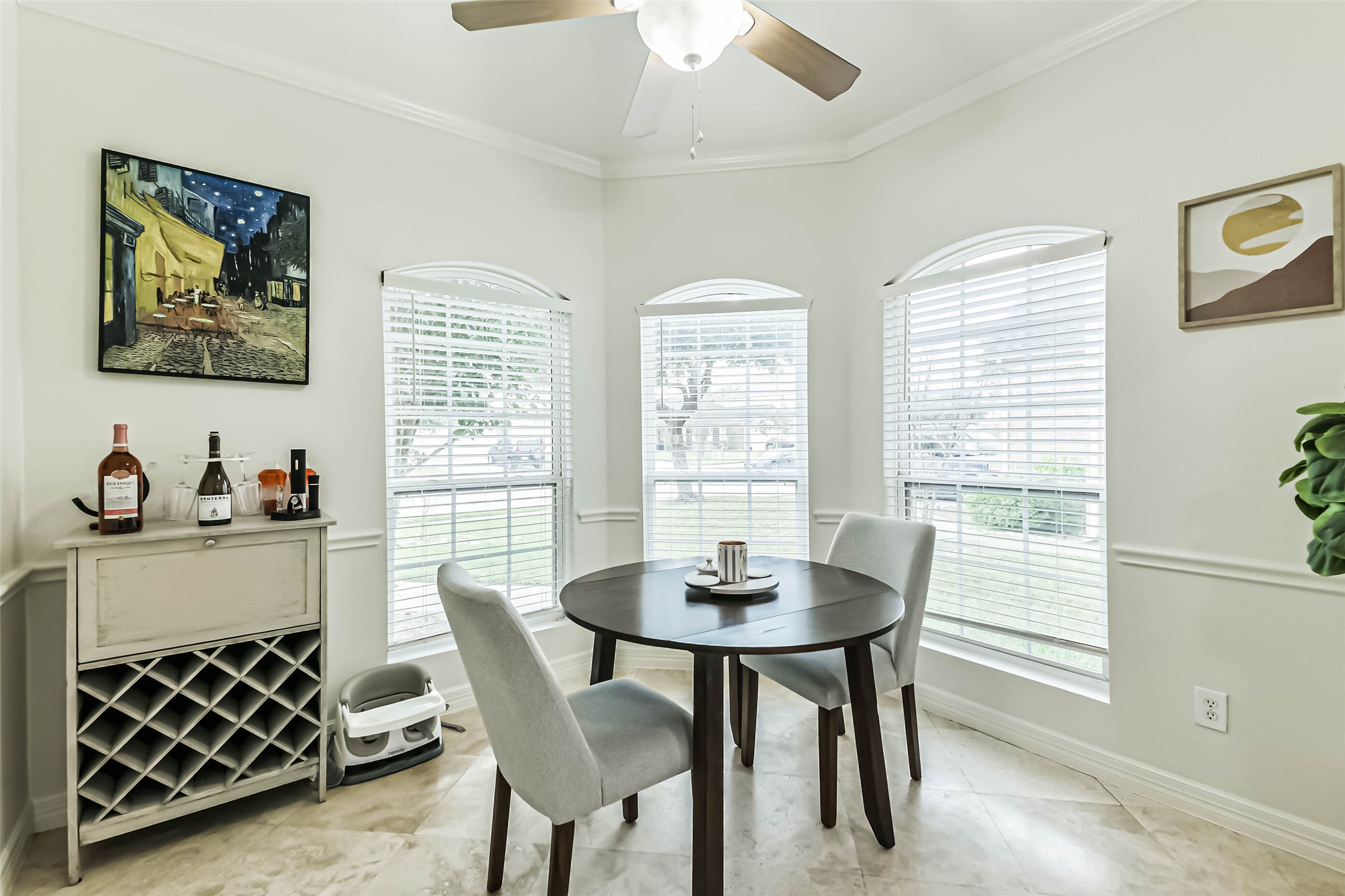 22538 Goss Spring Court Spring, TX 77373 - Photo 14 of 36 Bright dining nook with large windows, offering plenty of natural light. Features a round table with elegant chairs, a wine rack, and tasteful wall art. Perfect for intimate meals or morning coffee.
