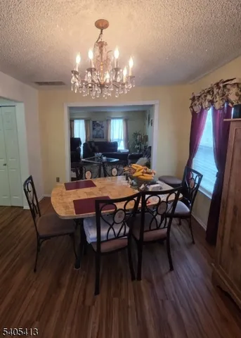 a view of a dining room with furniture and chandelier