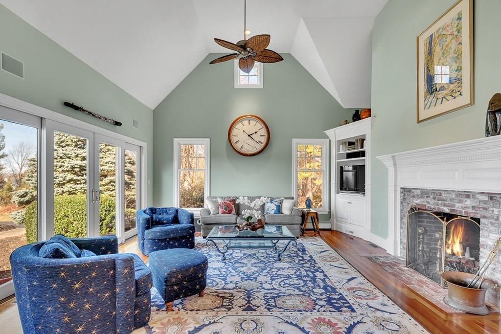 103 Kettle Hole Road Bolton, MA 01740 - Photo 8 of 40 a living room with furniture a fireplace and a large window
