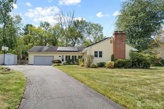 a front view of a house with a garden and yard