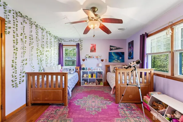 a bedroom with furniture and a large window