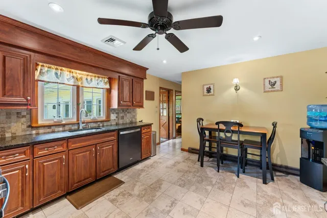 a kitchen with stainless steel appliances granite countertop a stove and a sink