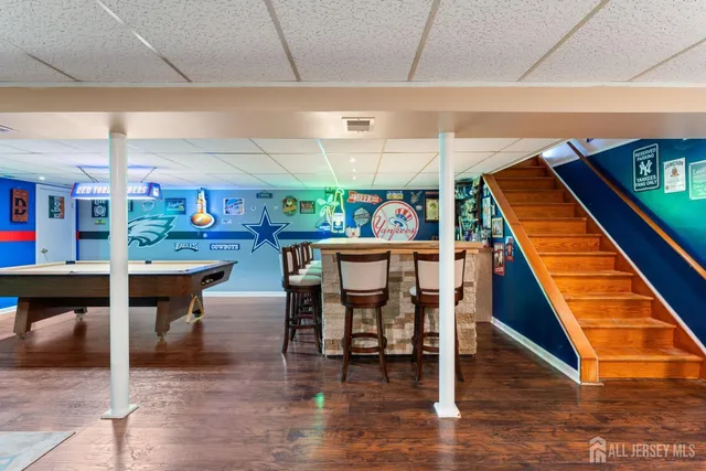 a room with lots of wooden furniture and a chandelier