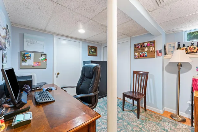 a view of a workspace with furniture and a window