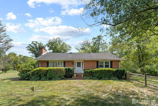 a front view of a house with plants