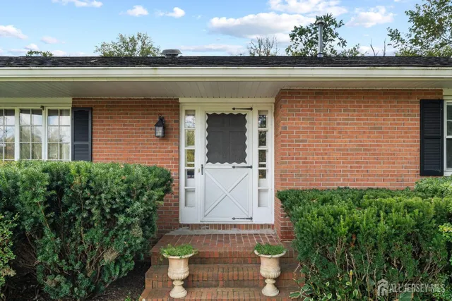 a view of a yard with wooden fence