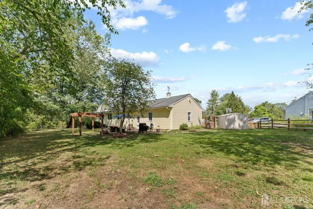 a view of a tables and chairs under an umbrella in the patio