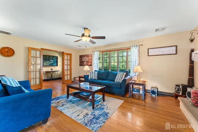 a living room with furniture wooden floor and a window