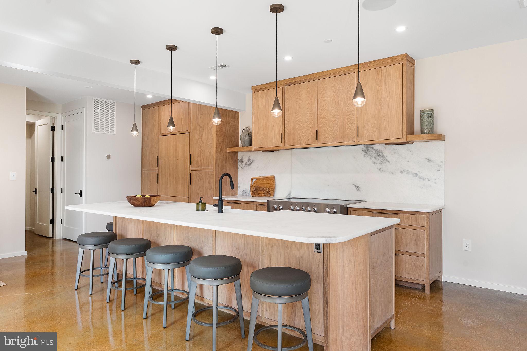 21 Overbeck Alley Northeast Washington, DC 20002 - Photo 18 of 63 a kitchen with a table chairs sink and cabinets
