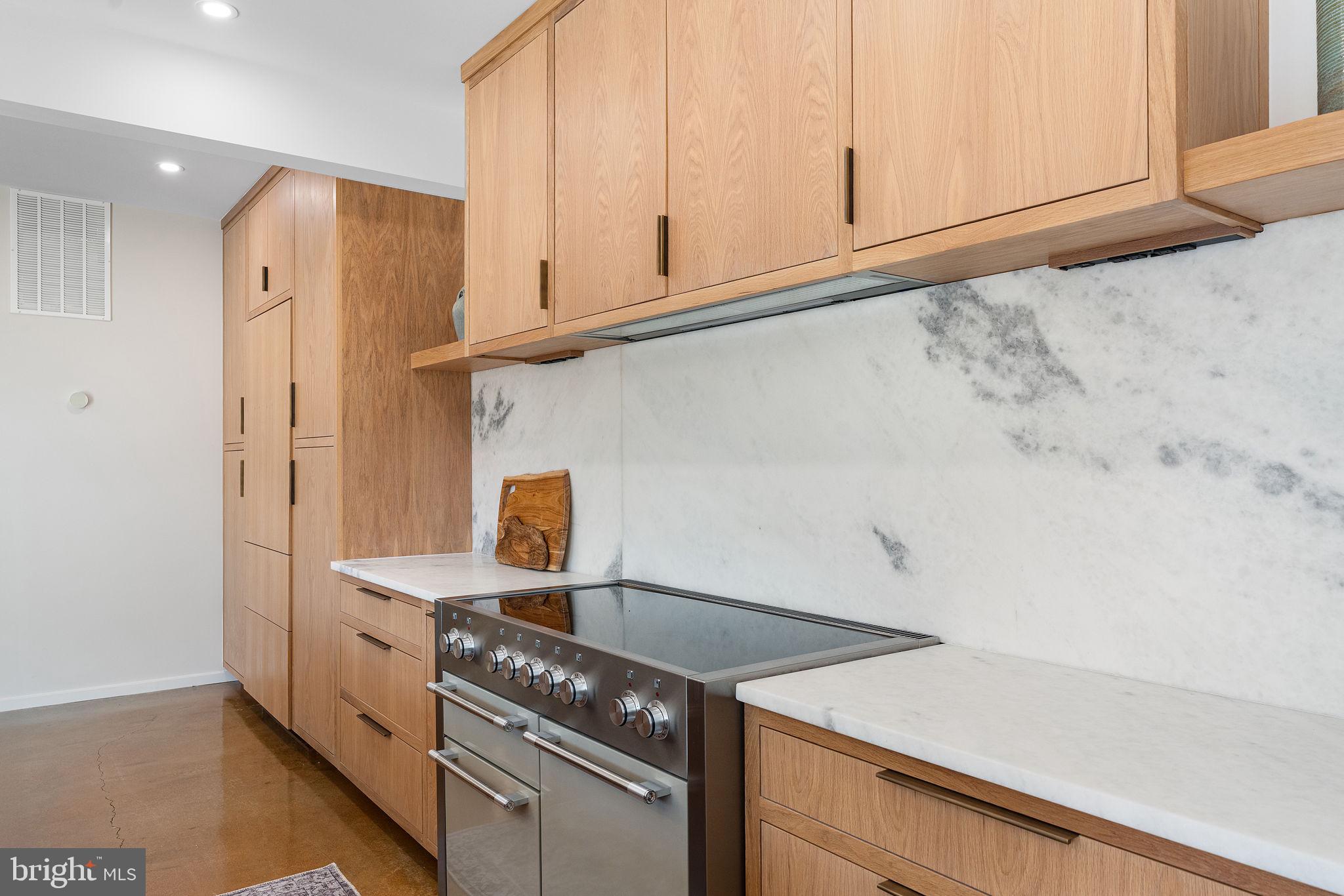 21 Overbeck Alley Northeast Washington, DC 20002 - Photo 20 of 63 a kitchen with granite countertop white cabinets and a stove