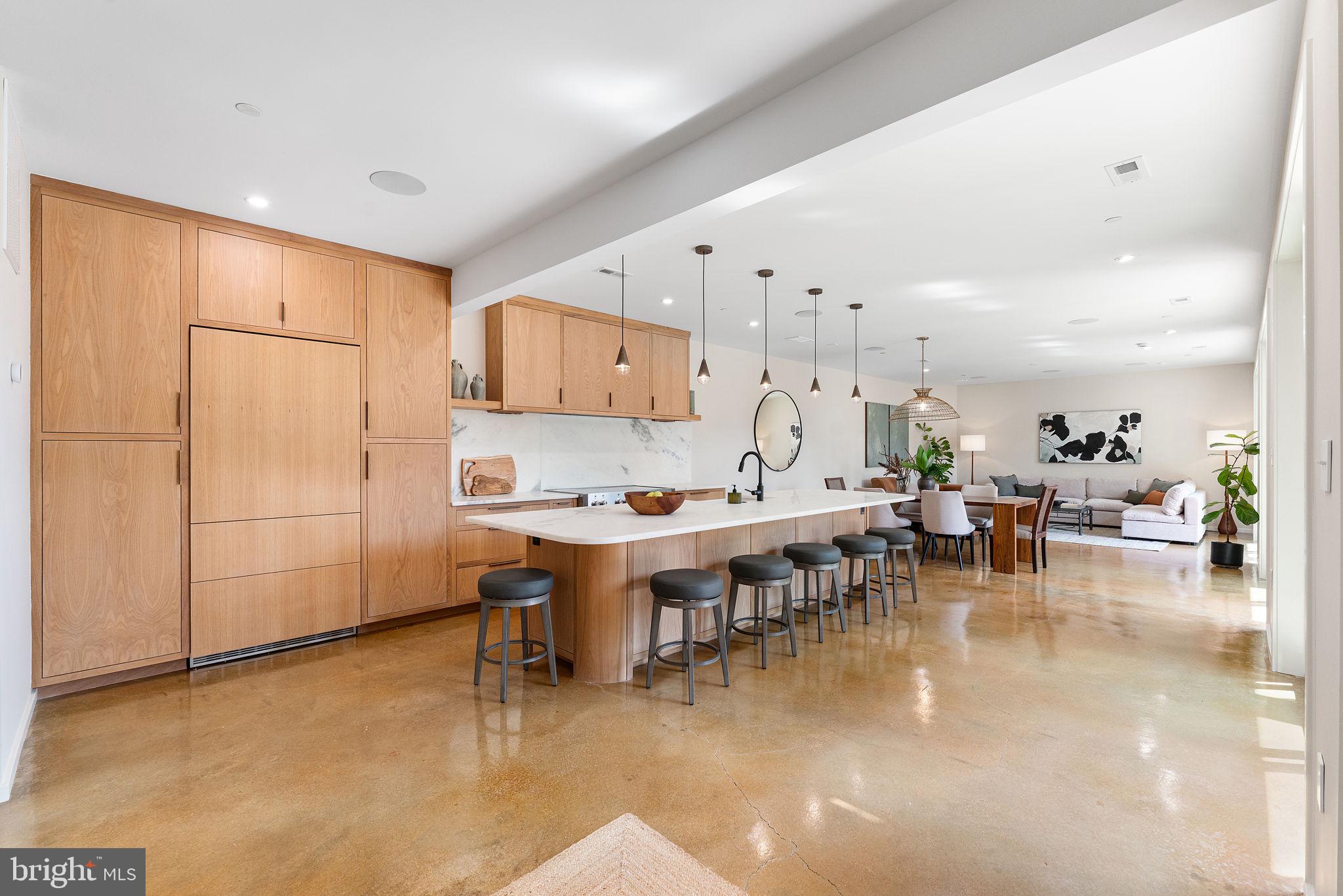21 Overbeck Alley Northeast Washington, DC 20002 - Photo 3 of 63 a dining hall with stainless steel appliances kitchen island granite countertop a table and chairs in it