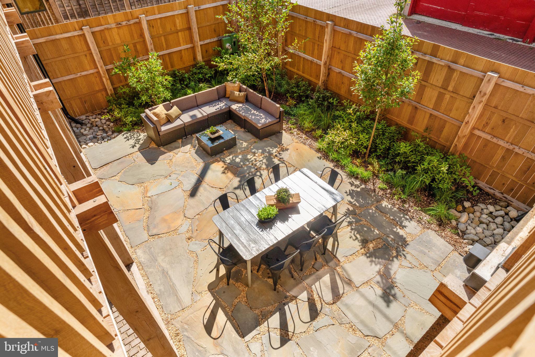 21 Overbeck Alley Northeast Washington, DC 20002 - Photo 47 of 63 a backyard of a house with outdoor seating