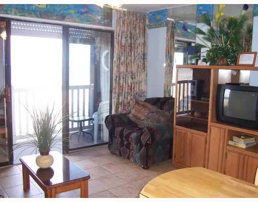 a living room with furniture a flat screen tv and a floor