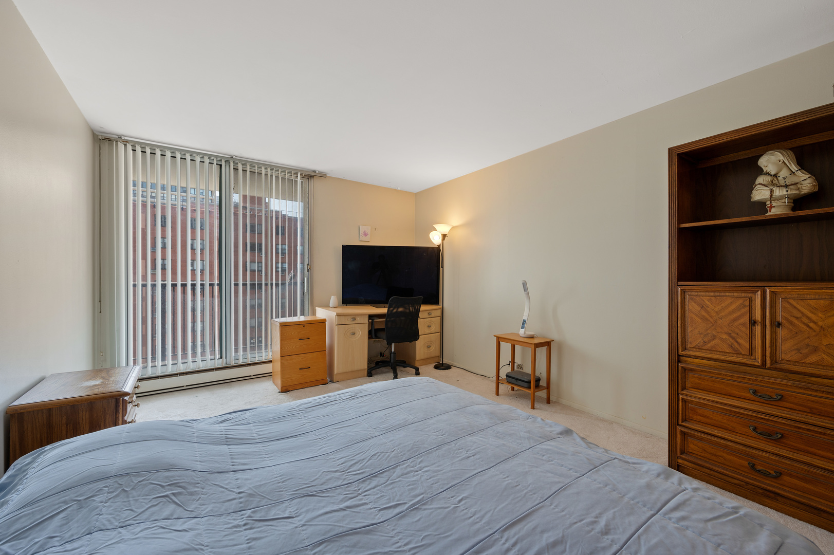 5855 North Sheridan Road, Unit 10G Chicago, IL 60660 - Photo 13 of 31 a bedroom with furniture and a flat screen tv