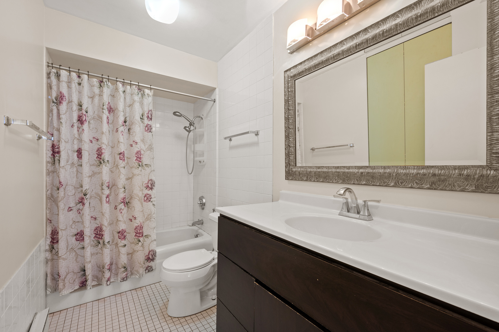 5855 North Sheridan Road, Unit 10G Chicago, IL 60660 - Photo 16 of 31 a bathroom with a sink a toilet and shower curtain