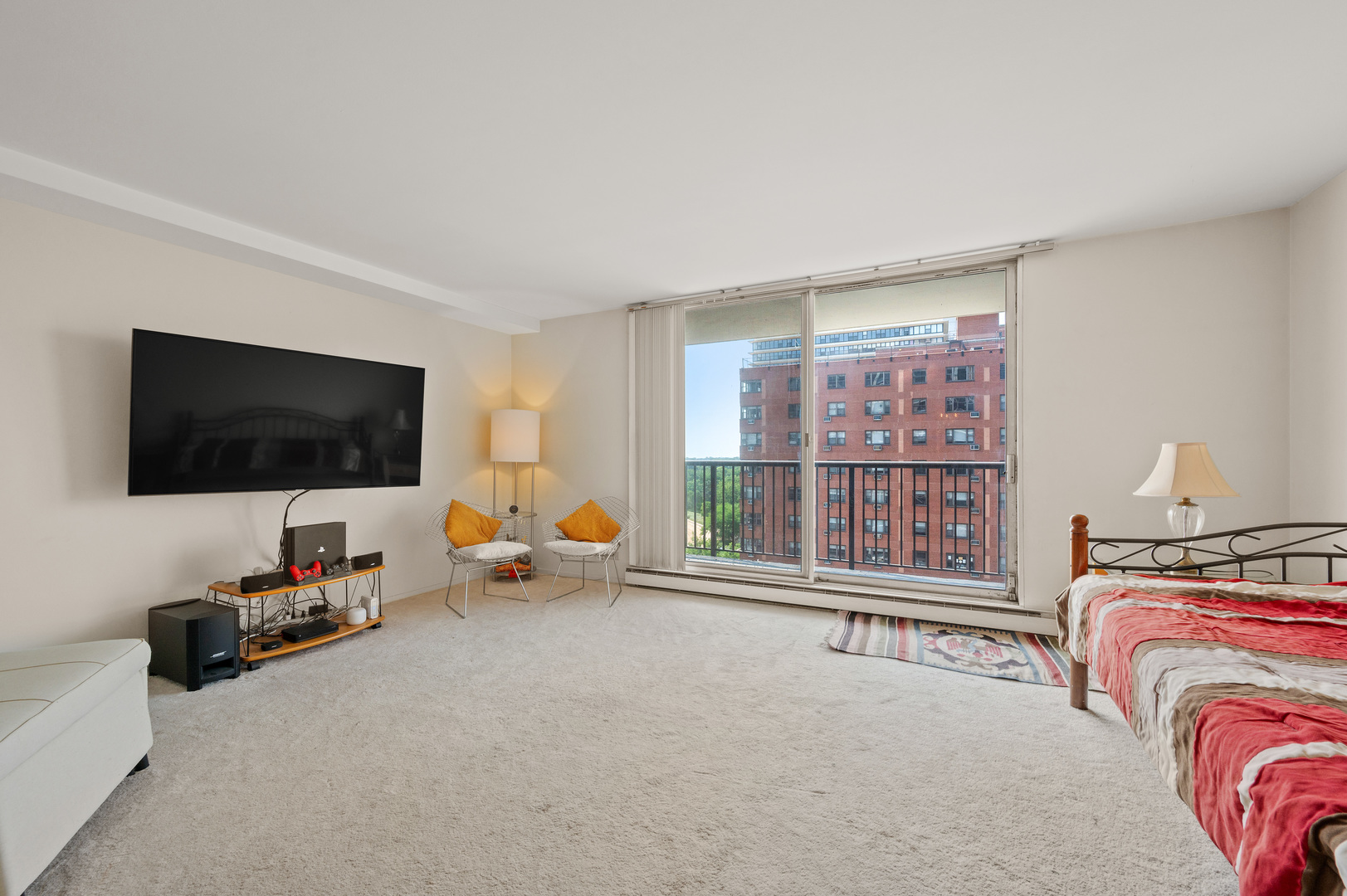 5855 North Sheridan Road, Unit 10G Chicago, IL 60660 - Photo 4 of 31 a living room with furniture and a flat screen tv