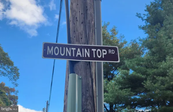 a street sign that is on a wooden wall