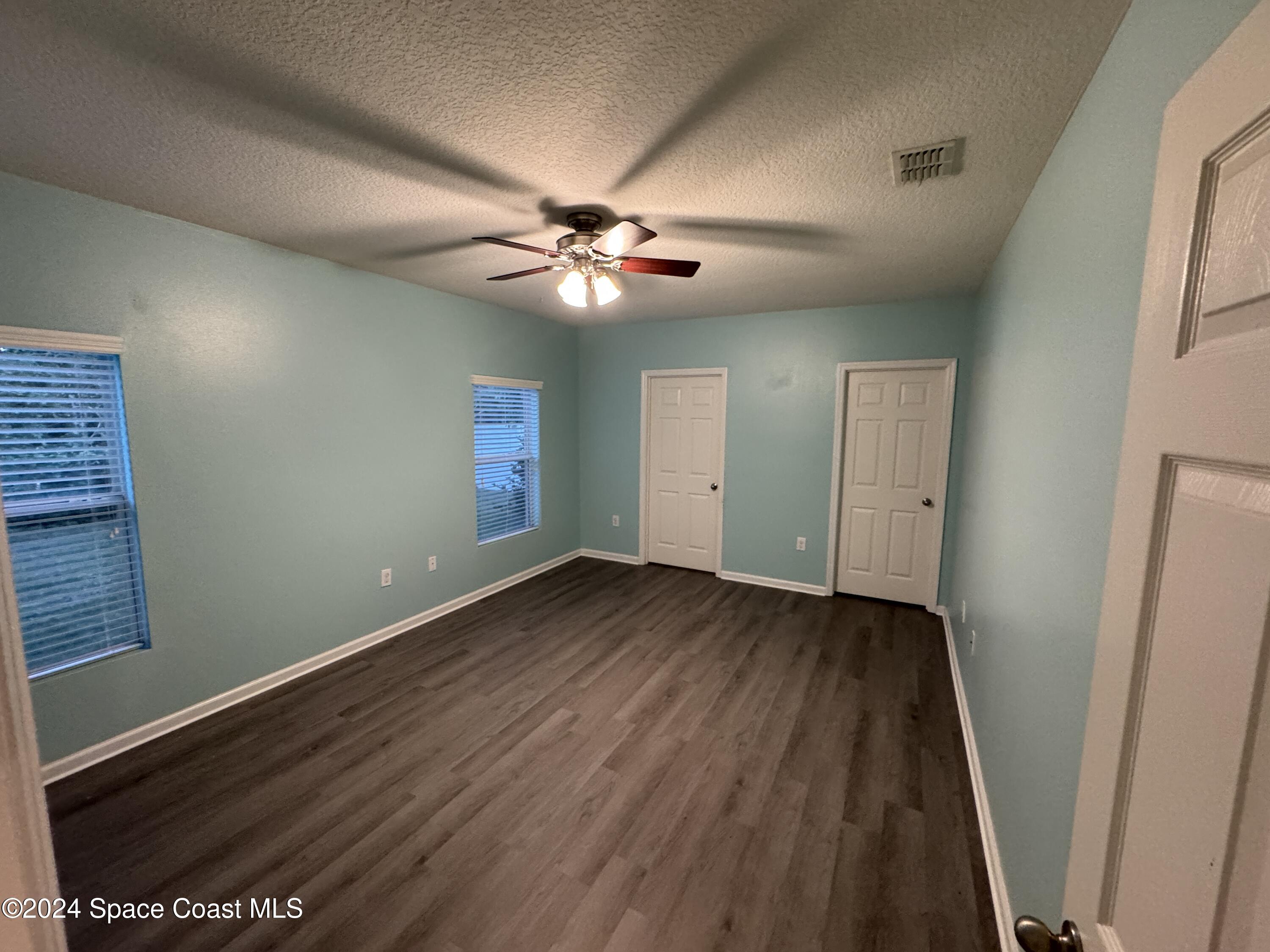 5281 Talbot Boulevard Cocoa, FL 32926 - Photo 14 of 31 wooden floor in an empty room with a window