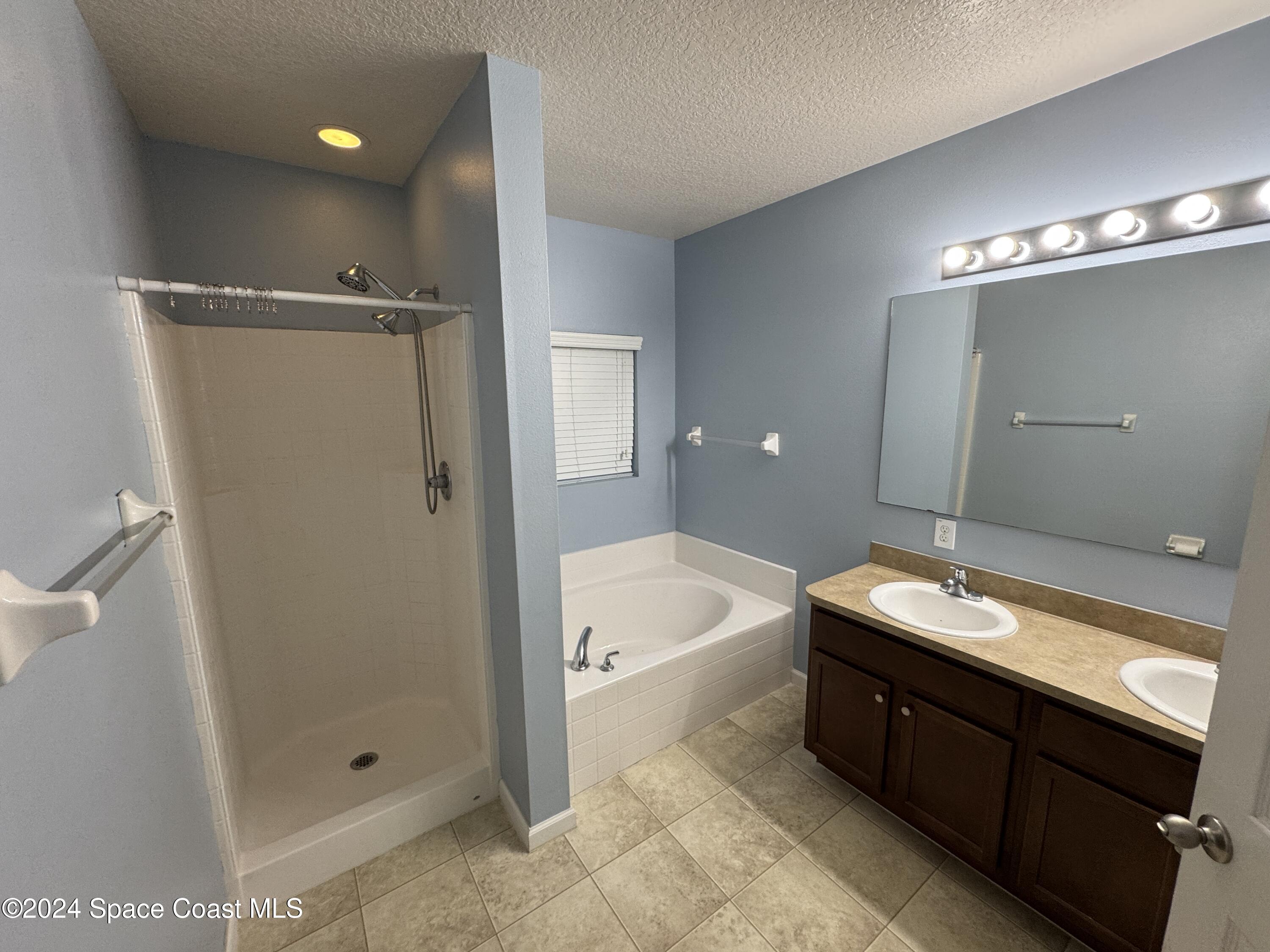 5281 Talbot Boulevard Cocoa, FL 32926 - Photo 18 of 31 a bathroom with a tub a sink and shower