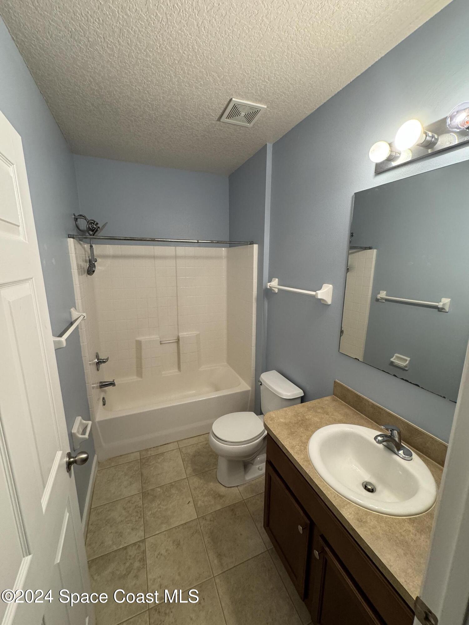 5281 Talbot Boulevard Cocoa, FL 32926 - Photo 24 of 31 a bathroom with a sink a toilet a mirror and shower
