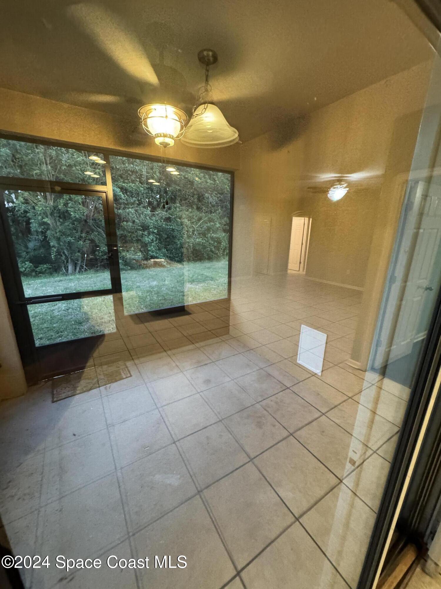 5281 Talbot Boulevard Cocoa, FL 32926 - Photo 26 of 31 a view of empty room with wooden floor and fan