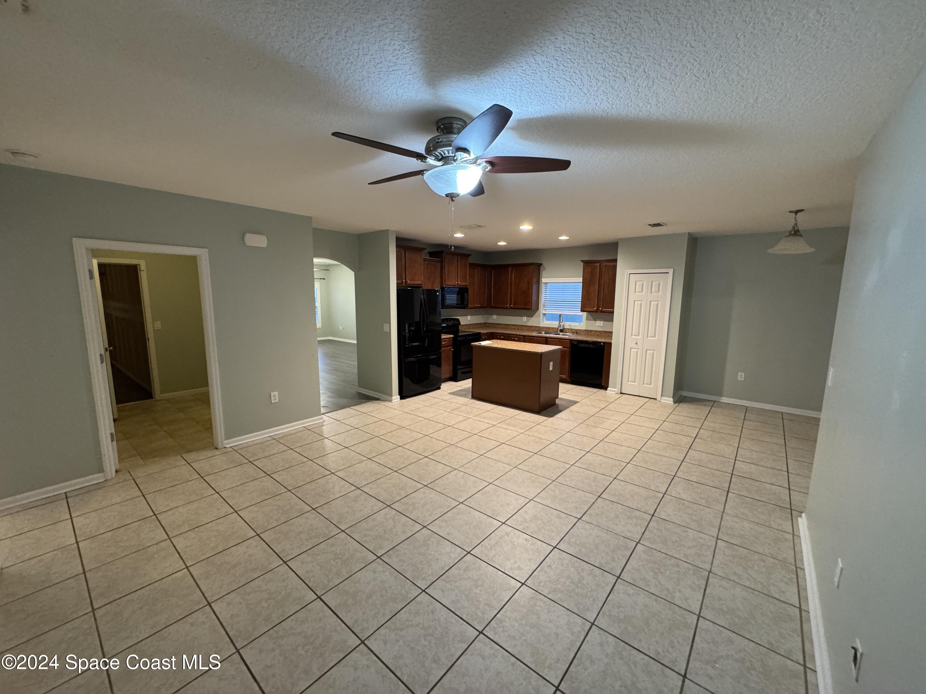 5281 Talbot Boulevard Cocoa, FL 32926 - Photo 7 of 31 a view of a kitchen with kitchen island stainless steel appliances refrigerator sink and cabinets