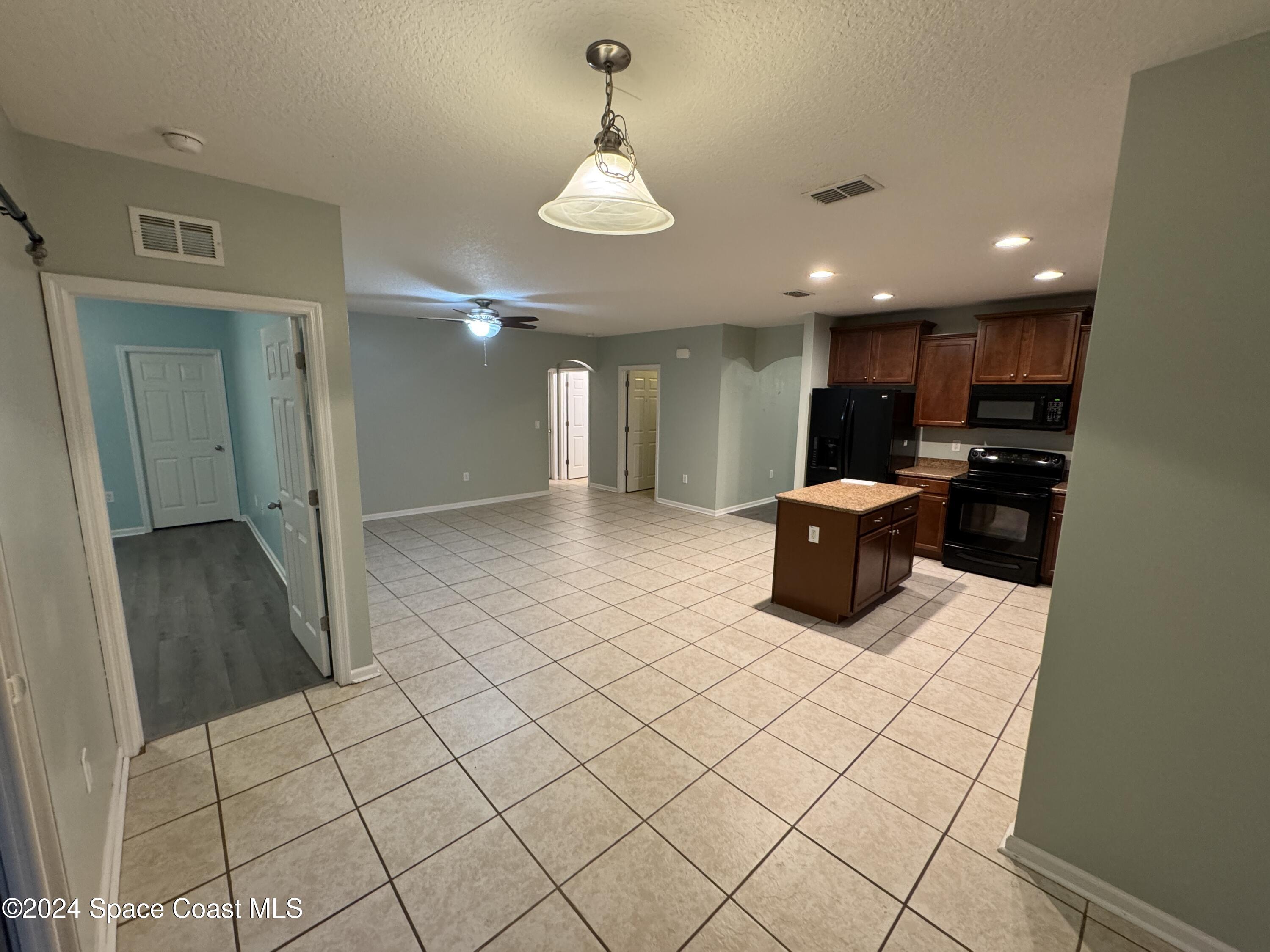 5281 Talbot Boulevard Cocoa, FL 32926 - Photo 8 of 31 a kitchen with stainless steel appliances kitchen island granite countertop a sink and cabinets